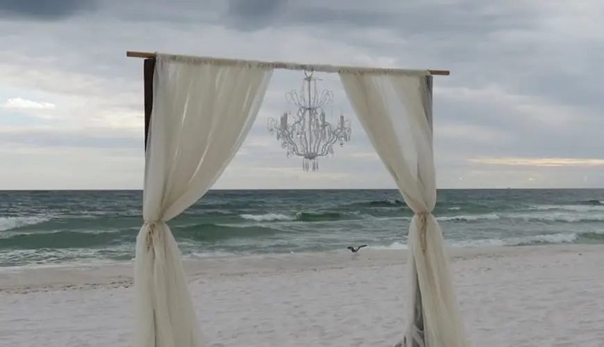 Arco con lampadario per il taglio torta in spiaggia